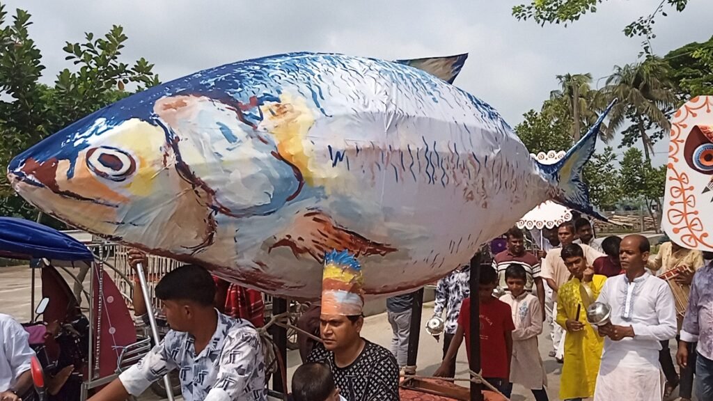 সড়কে বিশাল ইলিশ ও বক : পথে পথে বিতরণ করা হলো মুড়ি, বাতাসা, খই, জিলাপি